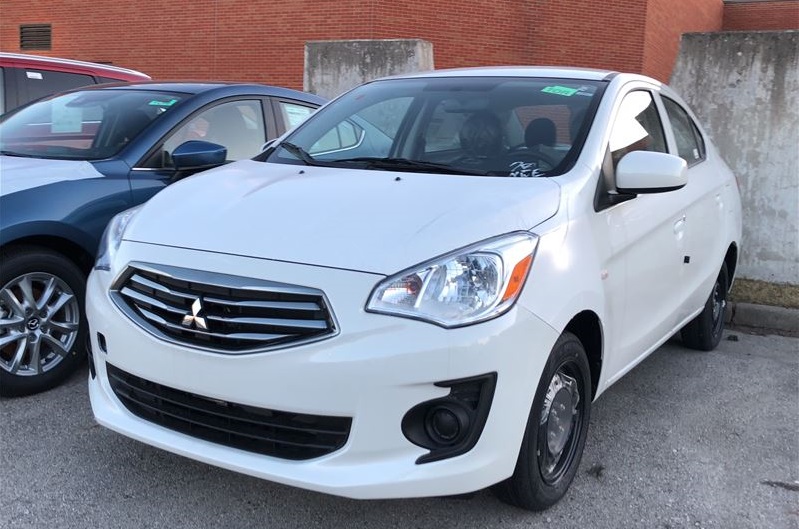 2018 White mitsubishi mirage small cheap car parked